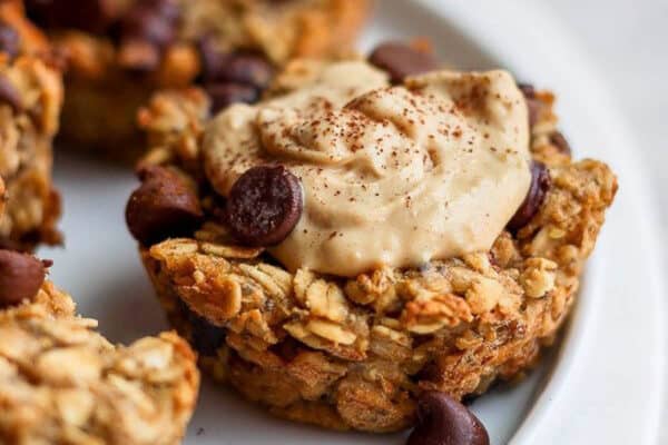 A baked oatmeal cup with almond butter and cinnamon on top.