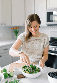 Erin Jensen, CEO of The Wooden Skillet, mixing a bowl of homemade guacamole in the kitchen.
